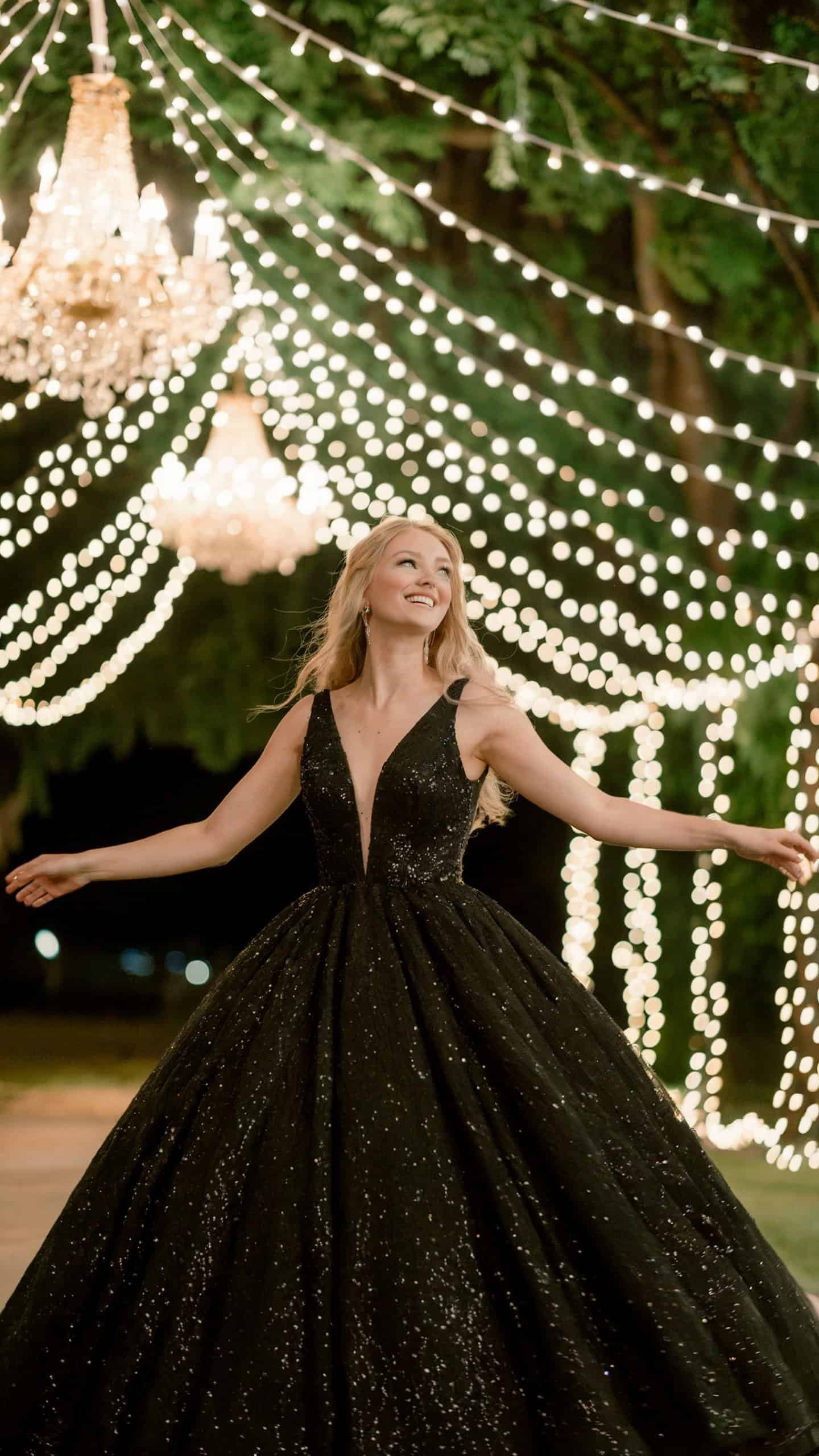 Black wedding dress with shimmering sequins and detachable train, ideal for evening receptions.