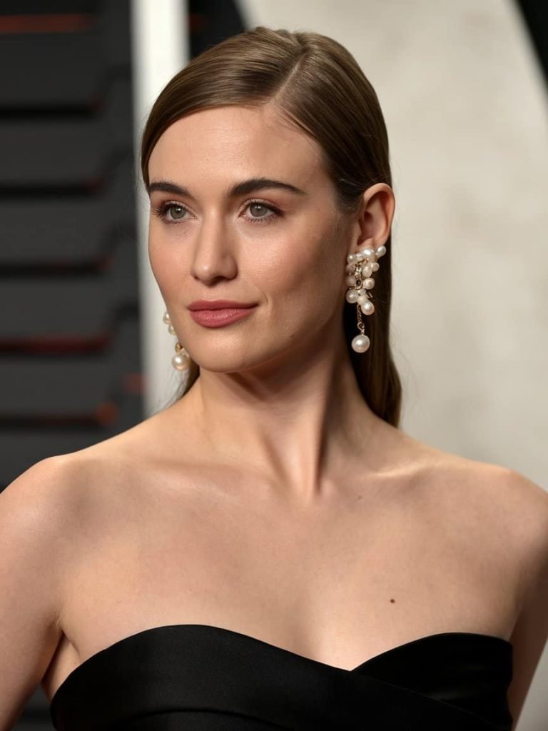 Beautiful sparkling studs elegantly framing a woman's face at a black tie event.