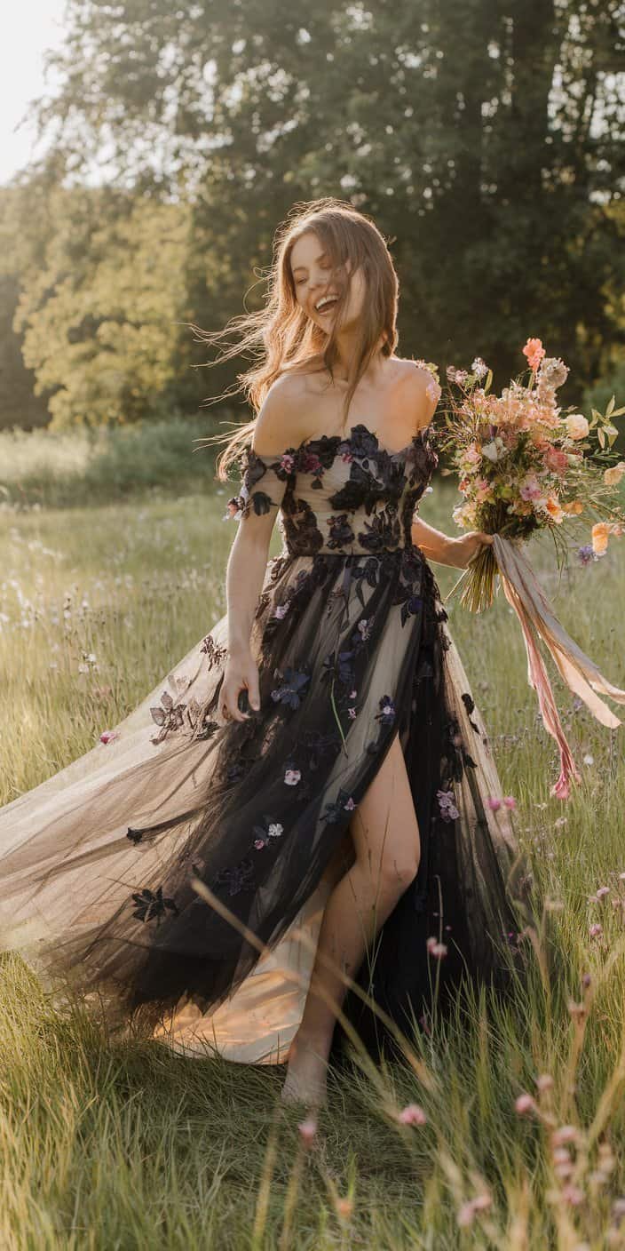Outdoor wedding bride in a black tulle dress, complemented by a bouquet of colorful wildflowers.
