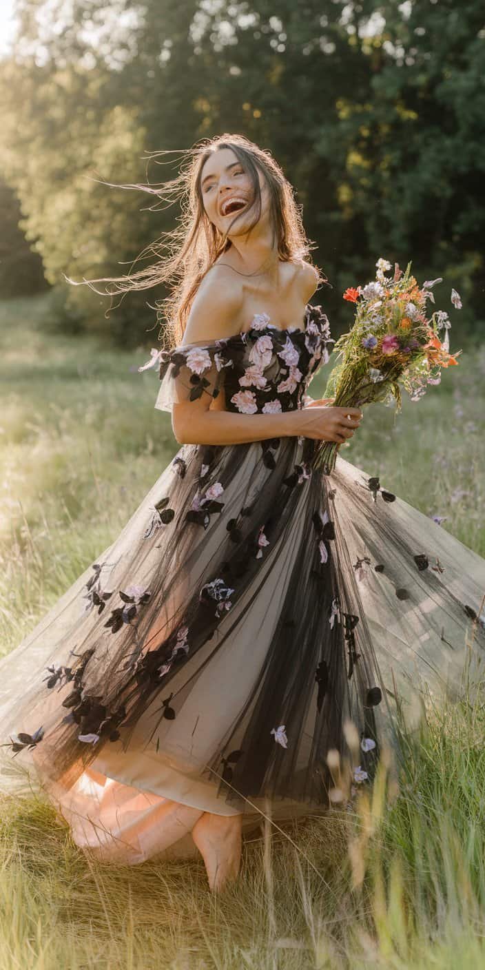 Romantic black bohemian wedding gown with flowing tulle layers and a dreamy aesthetic.