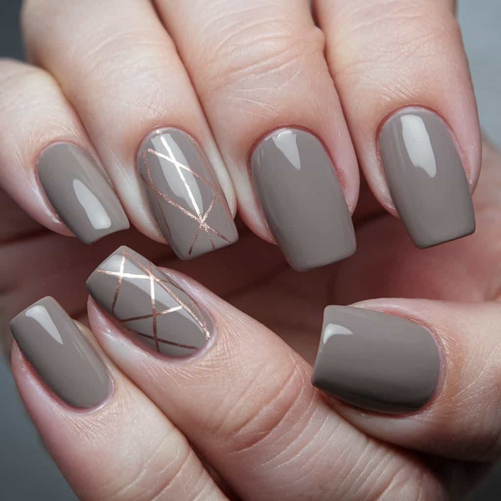 Close-up of Taupe Nude Nail art featuring geometric patterns in soft metallic tones