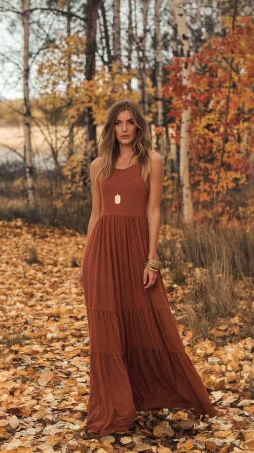 Flowing fall wedding guest dress in rust, featuring stylish bell sleeves