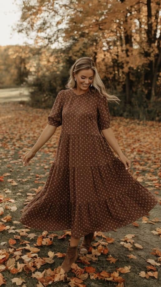 A blonde woman wears a stunning wedding guest dress in espresso brown