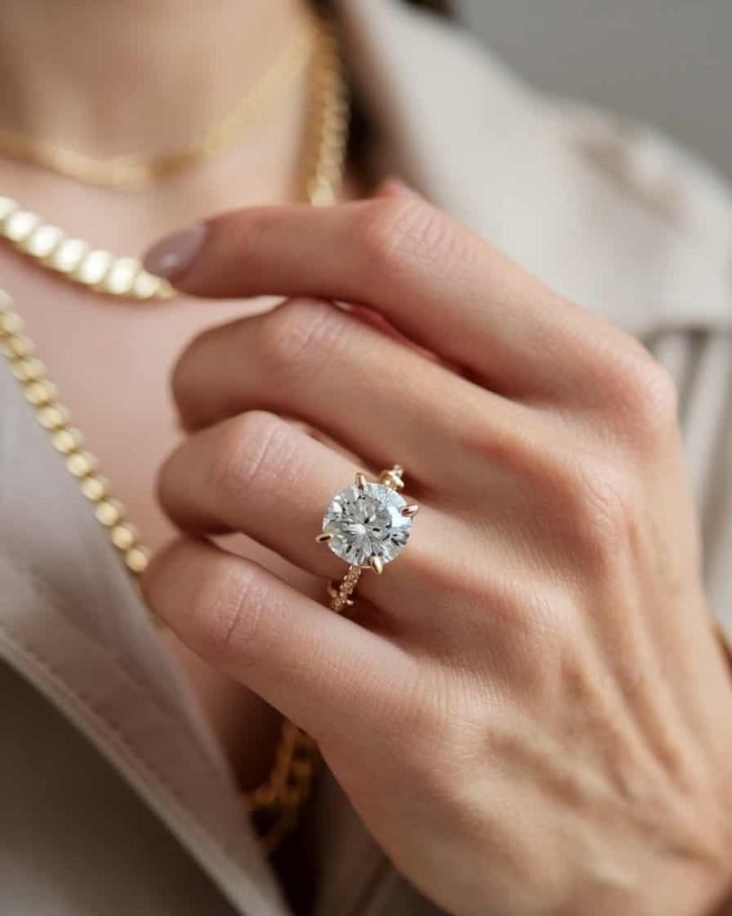 A modern gold ring set with a deep blue sapphire, elegantly photographed against a dark backdrop, drawing attention to the striking color contrast.