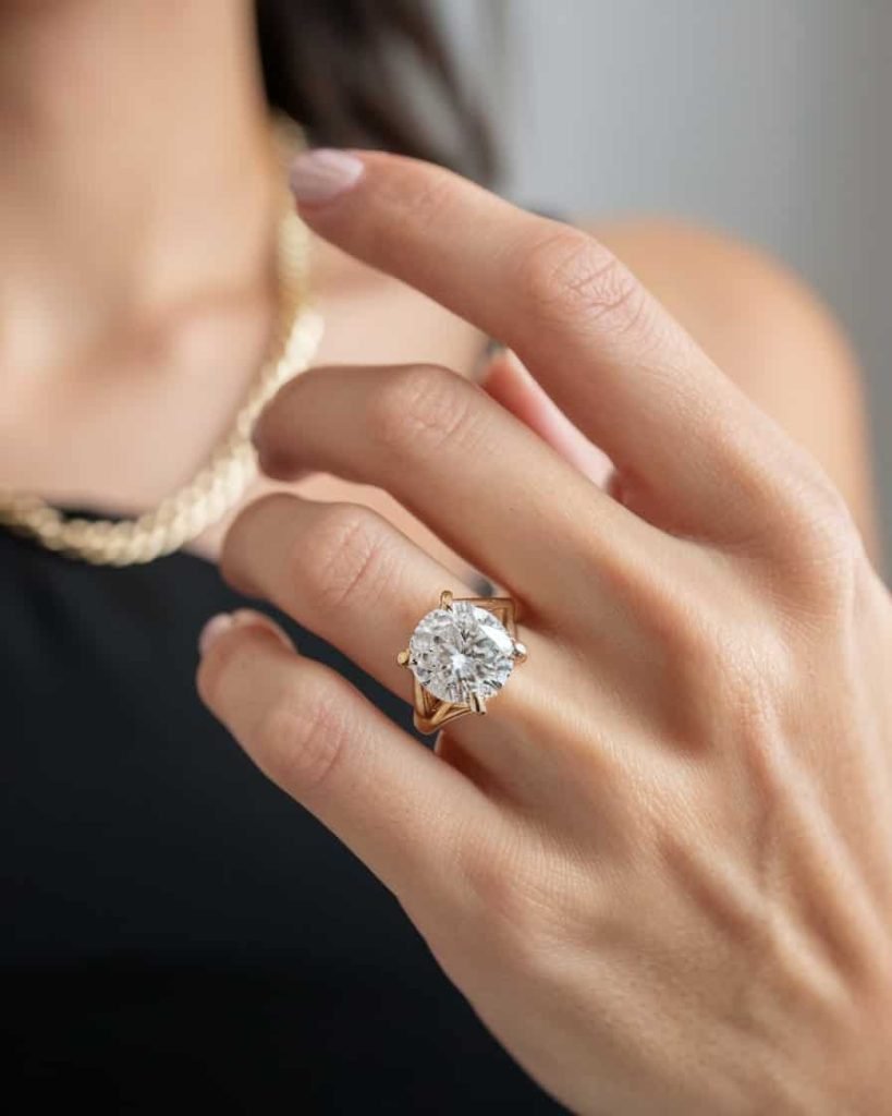 A stylish stack of mixed metal rings, combining gold, silver, and rose gold, displayed on a vibrant fabric background, highlighting their versatility and modern flair.