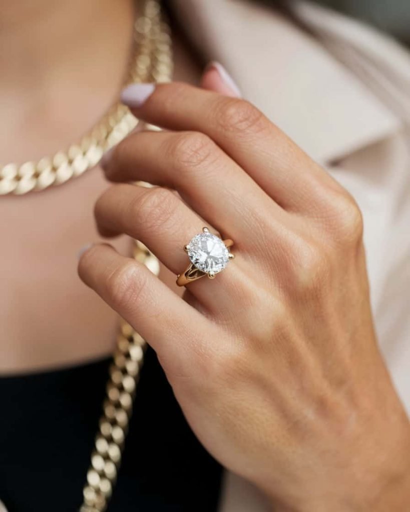 A close-up of a textured gold ring with a hammered finish, glinting in the light, emphasizing its contemporary craftsmanship and unique character.