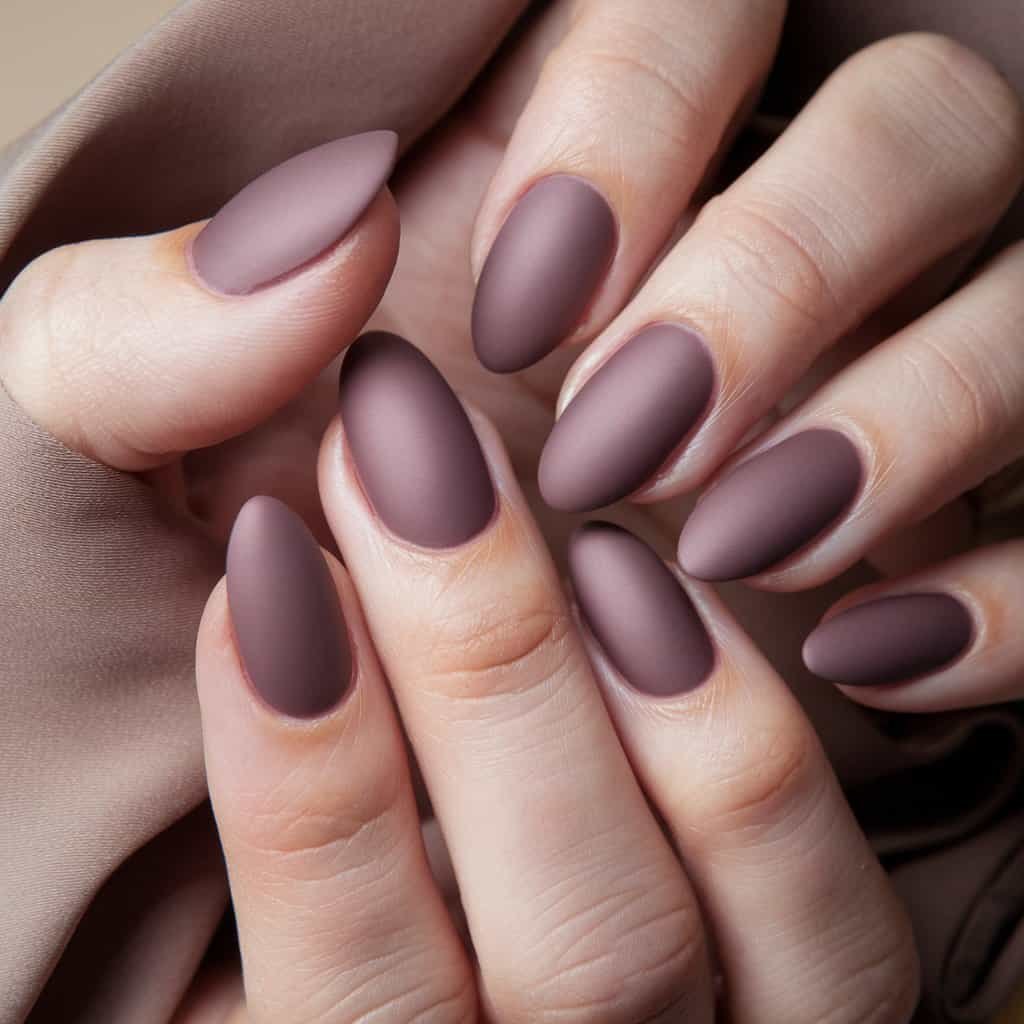 Stylish Muted Mauve Nude Nail design featuring a glossy finish that enhances its richness