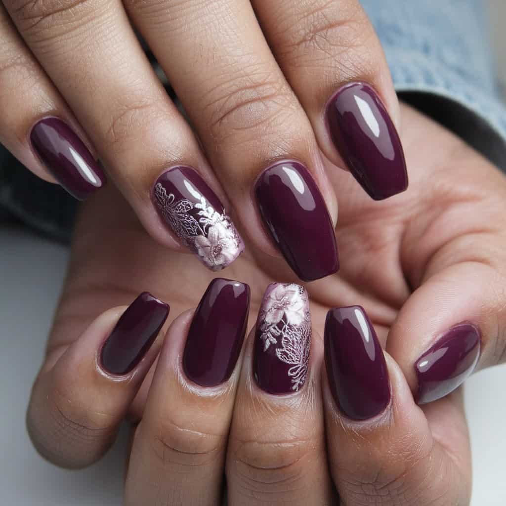 Close-up of Deep Plum Nude Nail art with intricate floral designs in soft gold