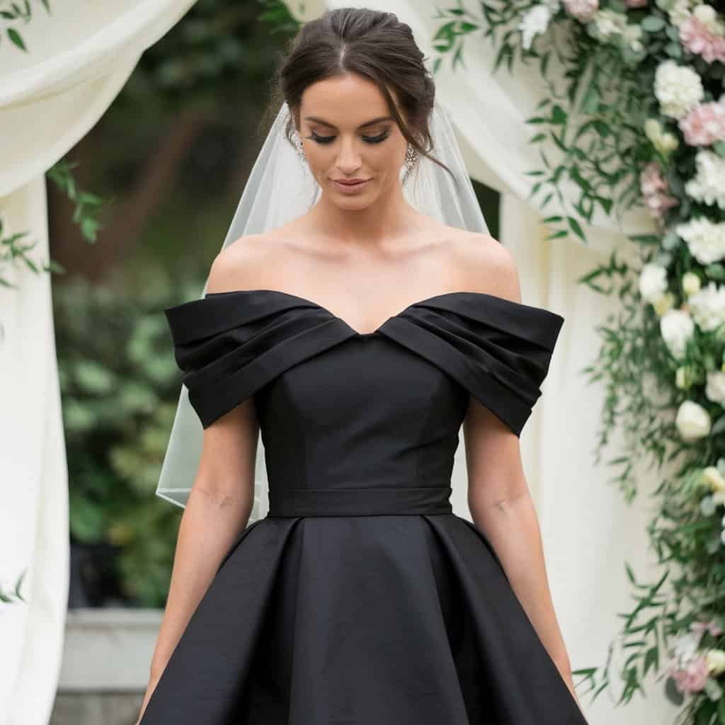 Black Wedding Guest Dresses: Off-Shoulder Charm with Delicate Detailing – A chic off-shoulder black dress with delicate detailing, perfect for adding a touch of sophistication to your wedding guest ensemble.