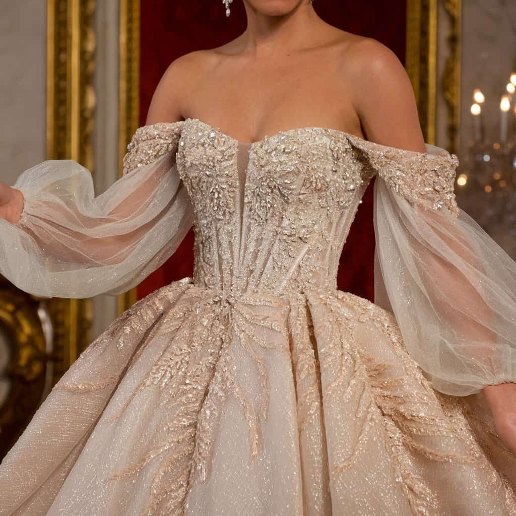 Dazzling gown featuring an off-the-shoulder design with intricate beading, capturing the essence of luxury and elegance.