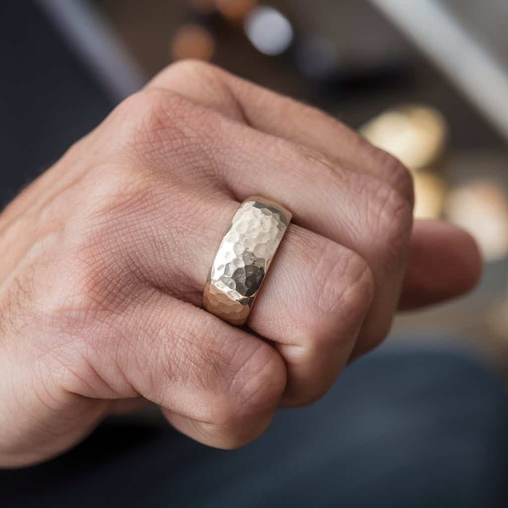 Rugged and textured men's white gold wedding band with a hammered surface, capturing a masculine style.