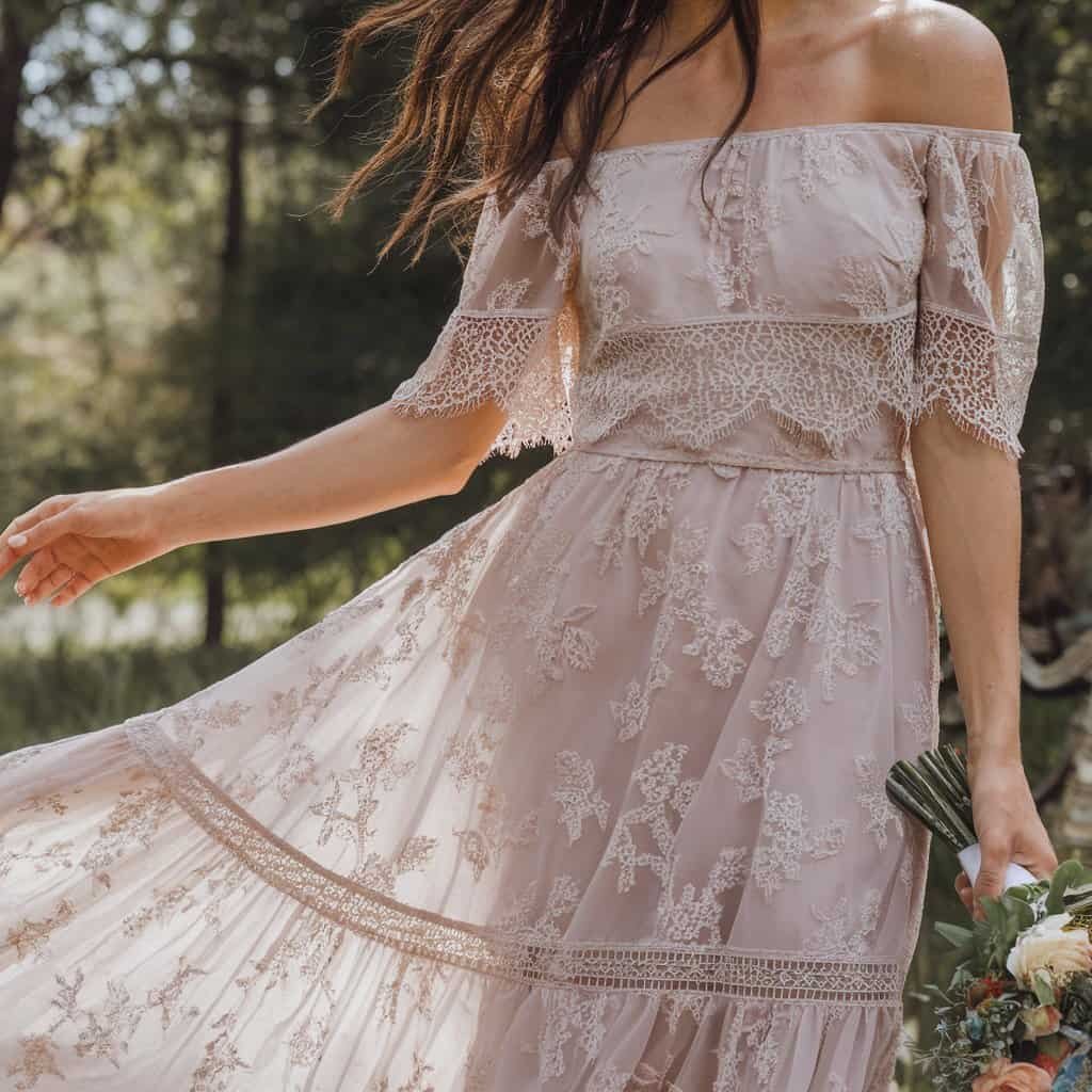 Chic royal wedding dress with delicate floral details and an off-the-shoulder design, ideal for a whimsical bridal theme.