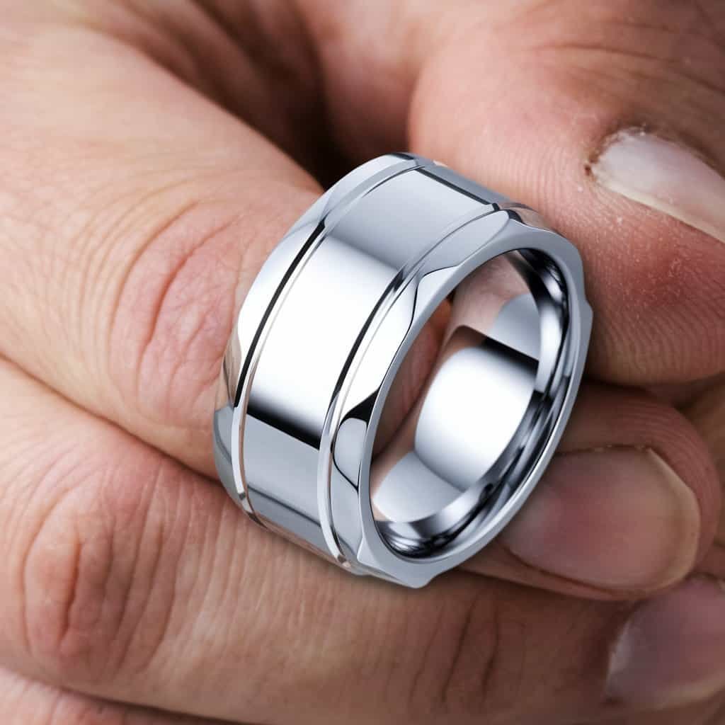 Close-up of a men's white gold wedding band featuring distinct beveled edges for a bold and masculine silhouette.