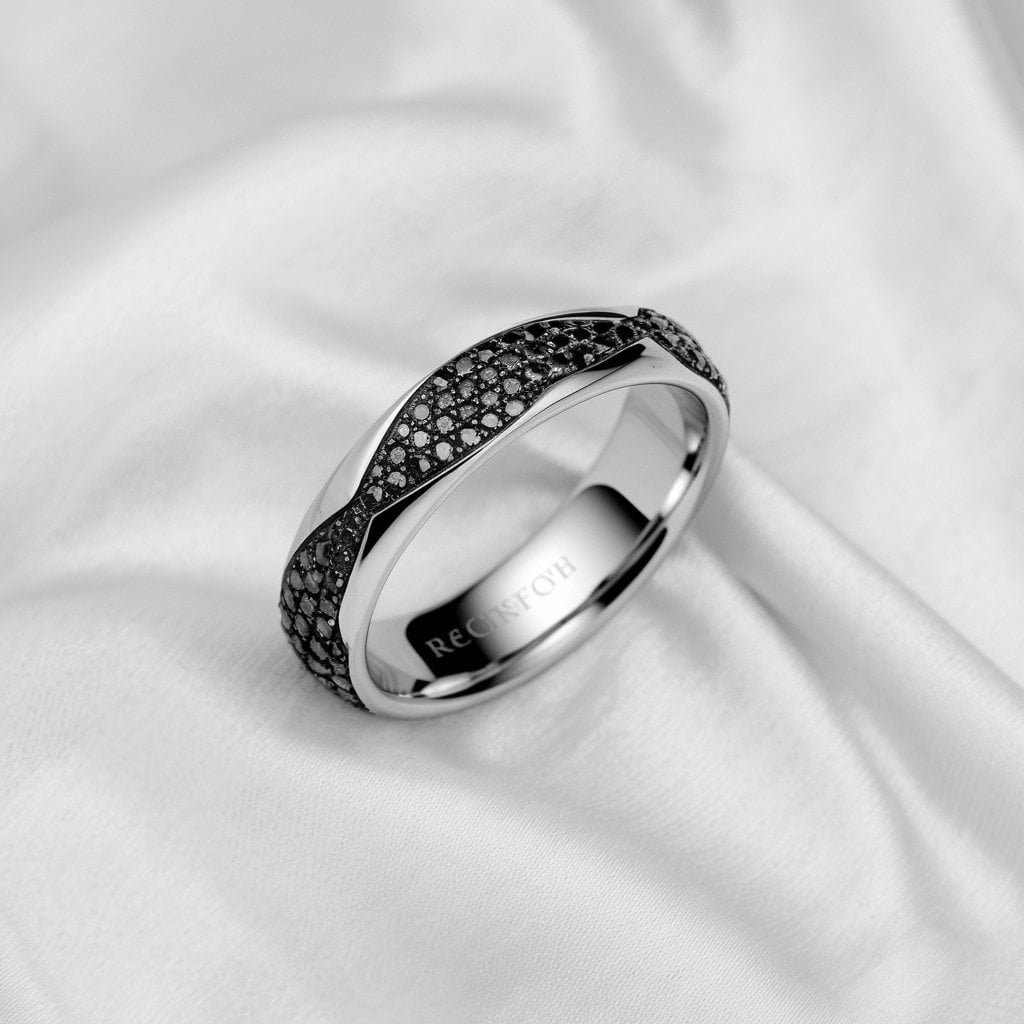Elegant men's white gold wedding band with black diamonds, offering a striking contrast between the white metal and dark stones.