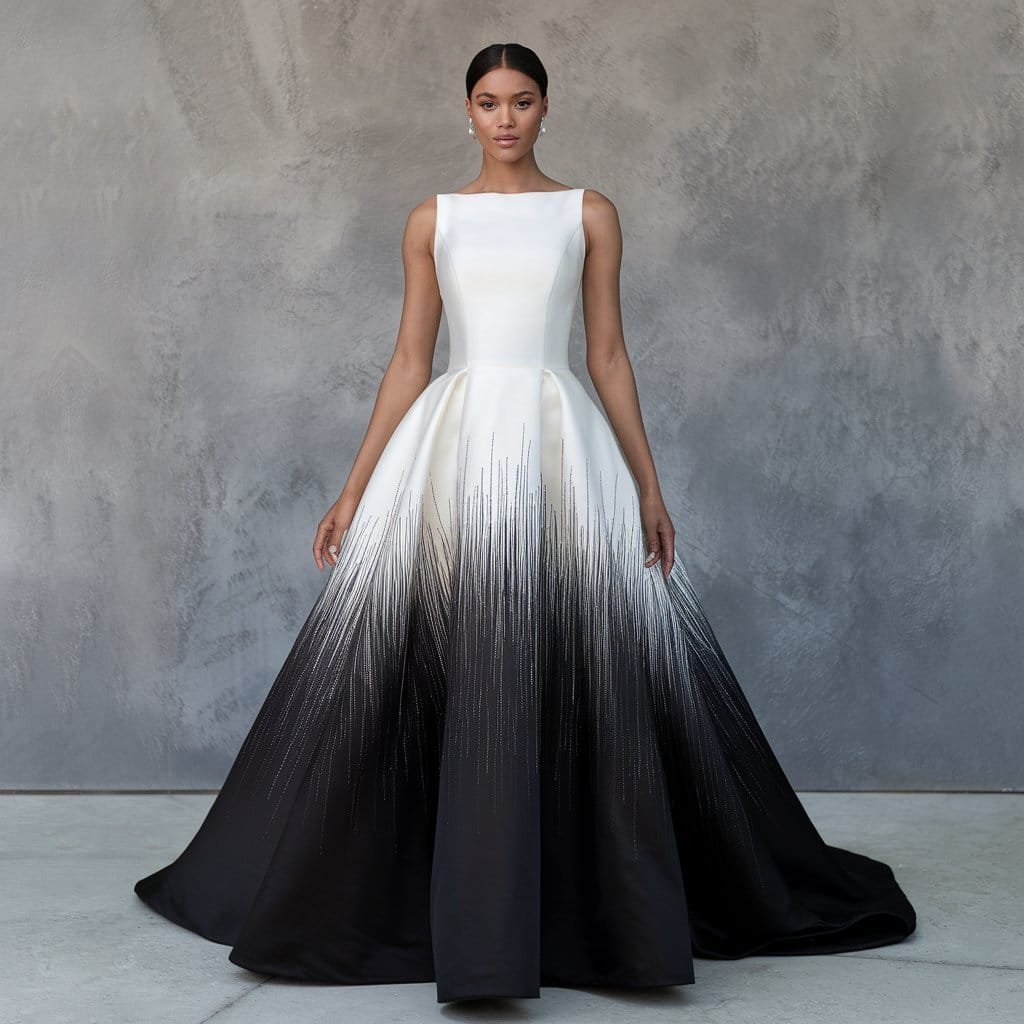 Elegant bride wearing black and white wedding dresses with an ombre design fading from white to black.
