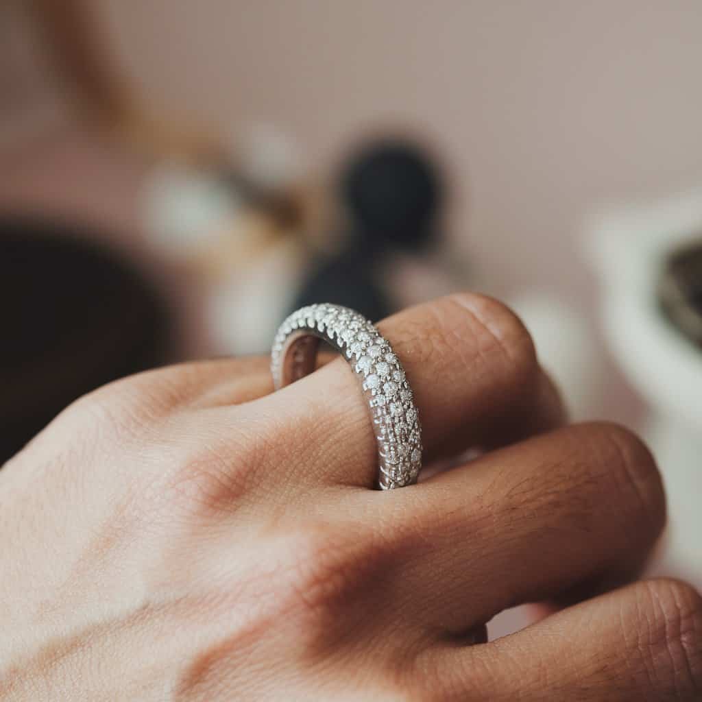 A sleek and polished men's white gold wedding band featuring diamonds set in a seamless channel for added sophistication.