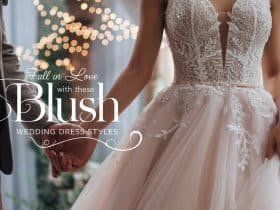 A bride in an elegant blush wedding dress with soft textures and fine embroidery, captured in a tender moment with her groom, highlighted by twinkling fairy lights and lush greenery in the background.