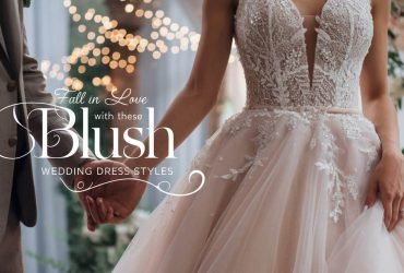 A bride in an elegant blush wedding dress with soft textures and fine embroidery, captured in a tender moment with her groom, highlighted by twinkling fairy lights and lush greenery in the background.