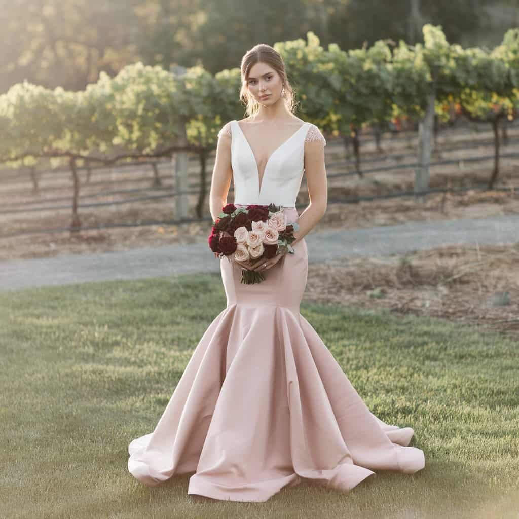 Bride in a wine-colored mermaid gown, a figure-flattering option among red wedding dresses.