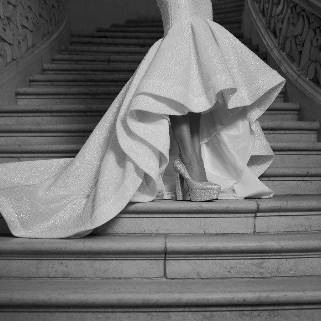 Bride at a grand staircase in Cushioned Platform Pumps – Comfortable Wedding Shoes for height and style.