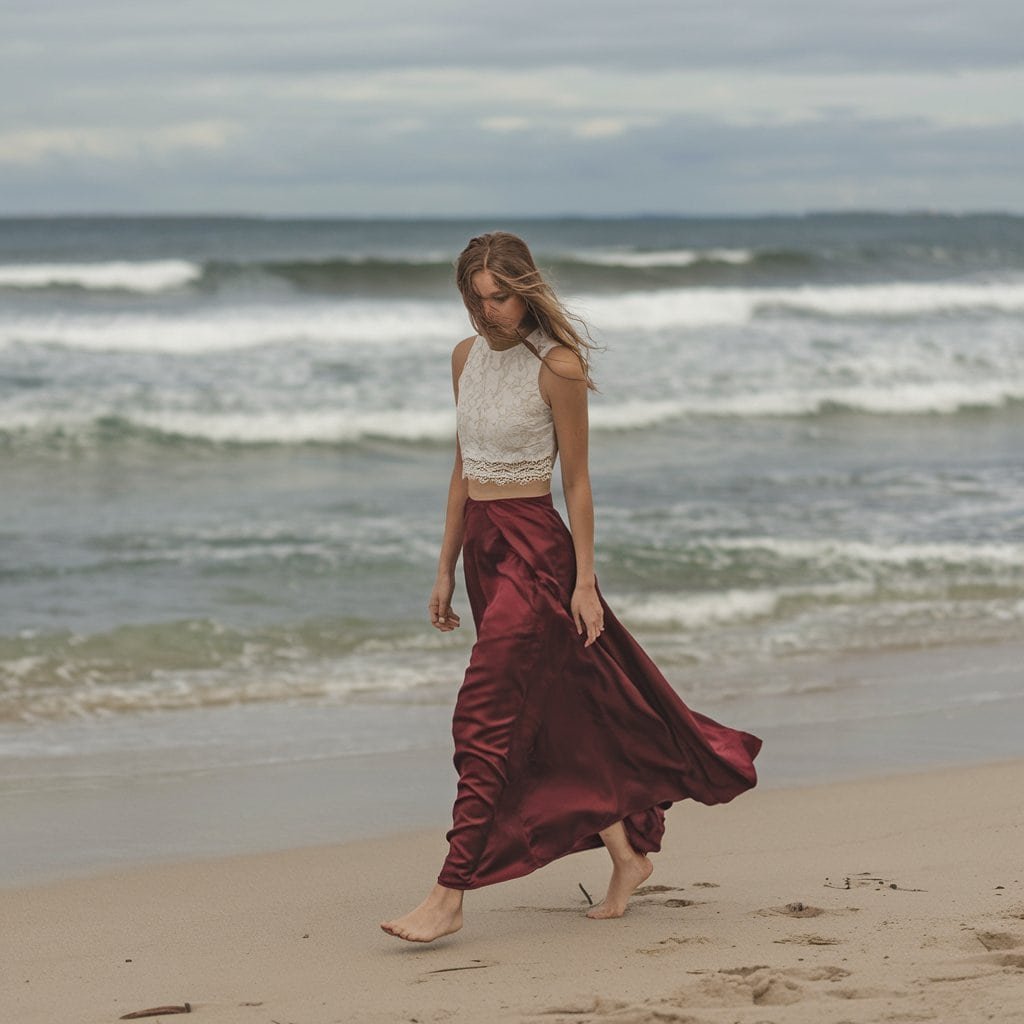 Flowing silk skirt and cropped lace top in a two-piece red wedding dress, ideal for contemporary brides.