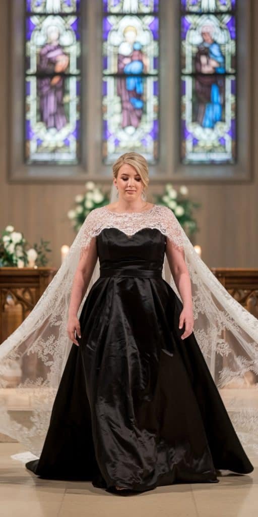 Stylish plus size black wedding dress with removable lace cape for an enchanting look