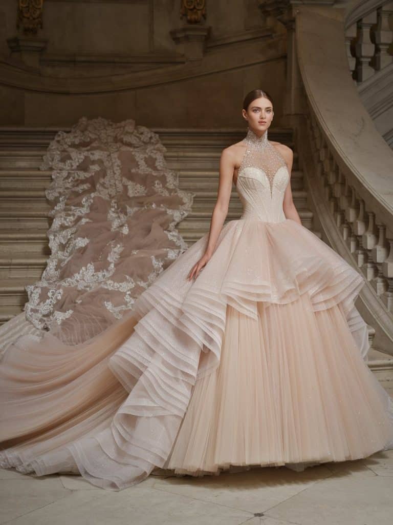 High-neck wedding dress with a voluminous ballgown silhouette, complete with tulle layers and shimmering details for a princess-like effect