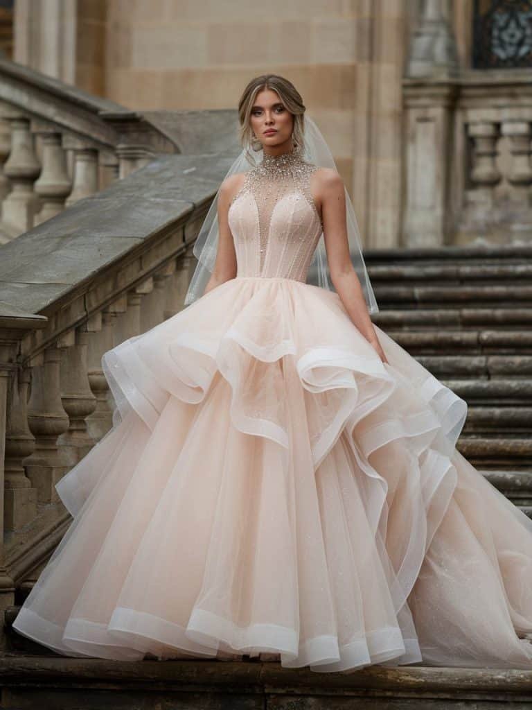 Elegant high-neck ballgown with sparkling accents and a striking train, perfect for a grand and dramatic wedding entrance