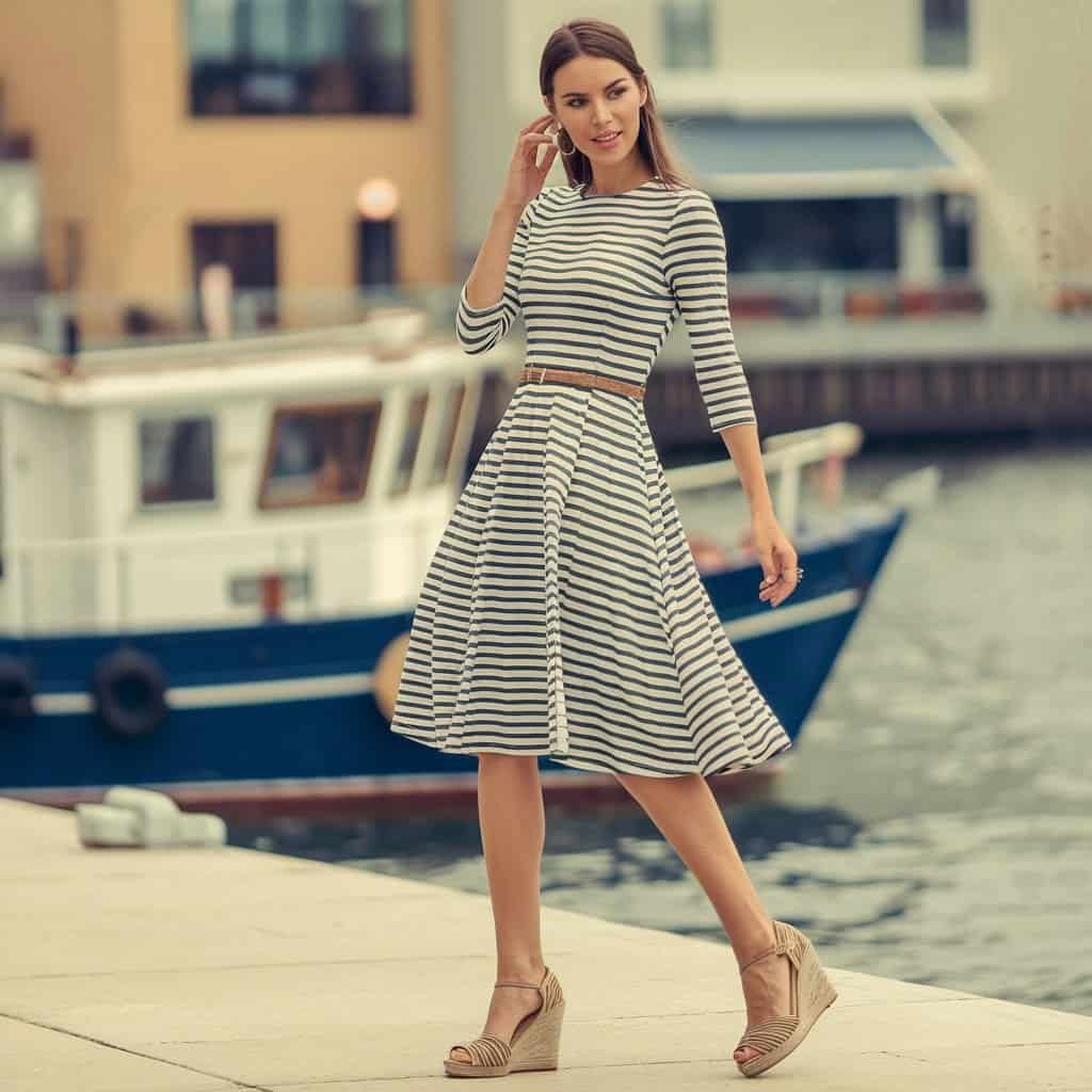 Model wearing a Striped Fit and Flare Dress with wedges, showcasing an elongated, flattering look