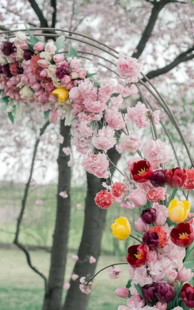 Monochromatic Wedding Arch Flowers in blush pink and white, perfect for a minimalist and chic wedding ceremony.
