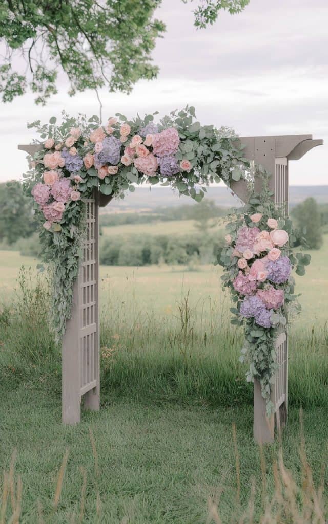 Soft and dreamy Wedding Arch Flowers in pastel hues of pink, lavender, and sage, perfect for a spring wedding ceremony.
