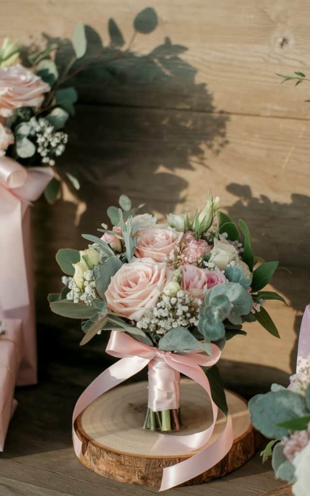 Wedding flowers arranged in small, elegant bouquets wrapped in ribbon, perfect for gifting to guests as a thank-you gesture after the wedding.
