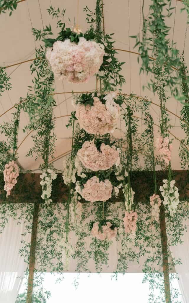 Stunning Wedding Arch Flowers with hanging floral installations, using clusters of blooms and cascading vines for a unique, breathtaking upside-down design.

